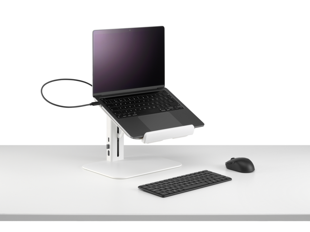 Lana laptop stand with laptop keyboard and mouse in white viewed from a sided angle.