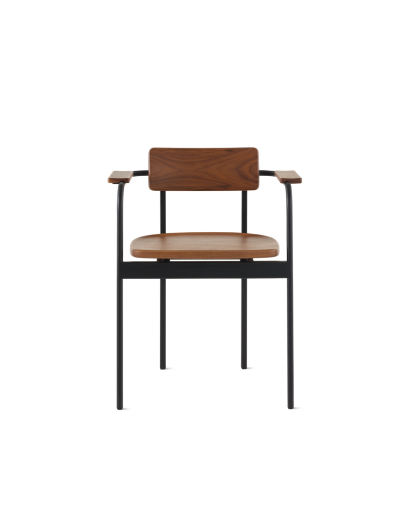 A Betwixt Chair with a walnut backrest, seat, and arms with a black frame.