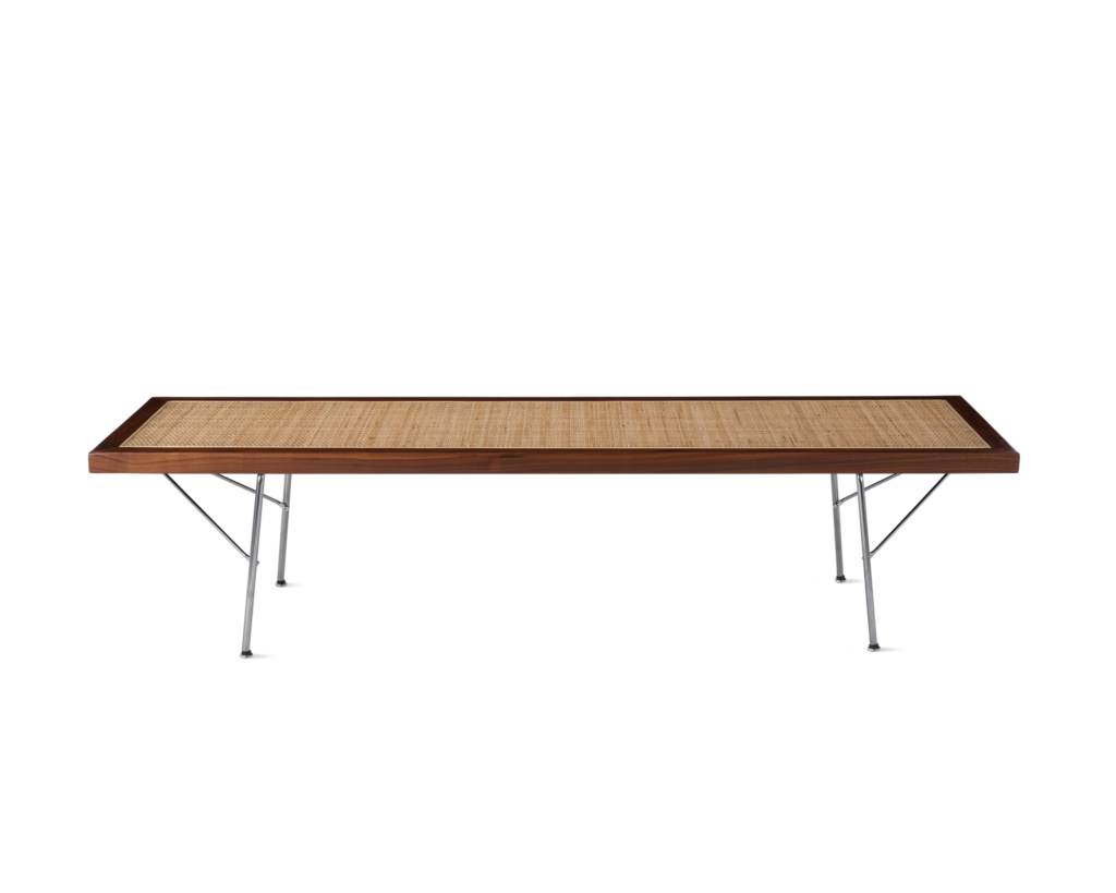 A Nelson Cane Bench with a walnut frame and metal legs, viewed from the side.