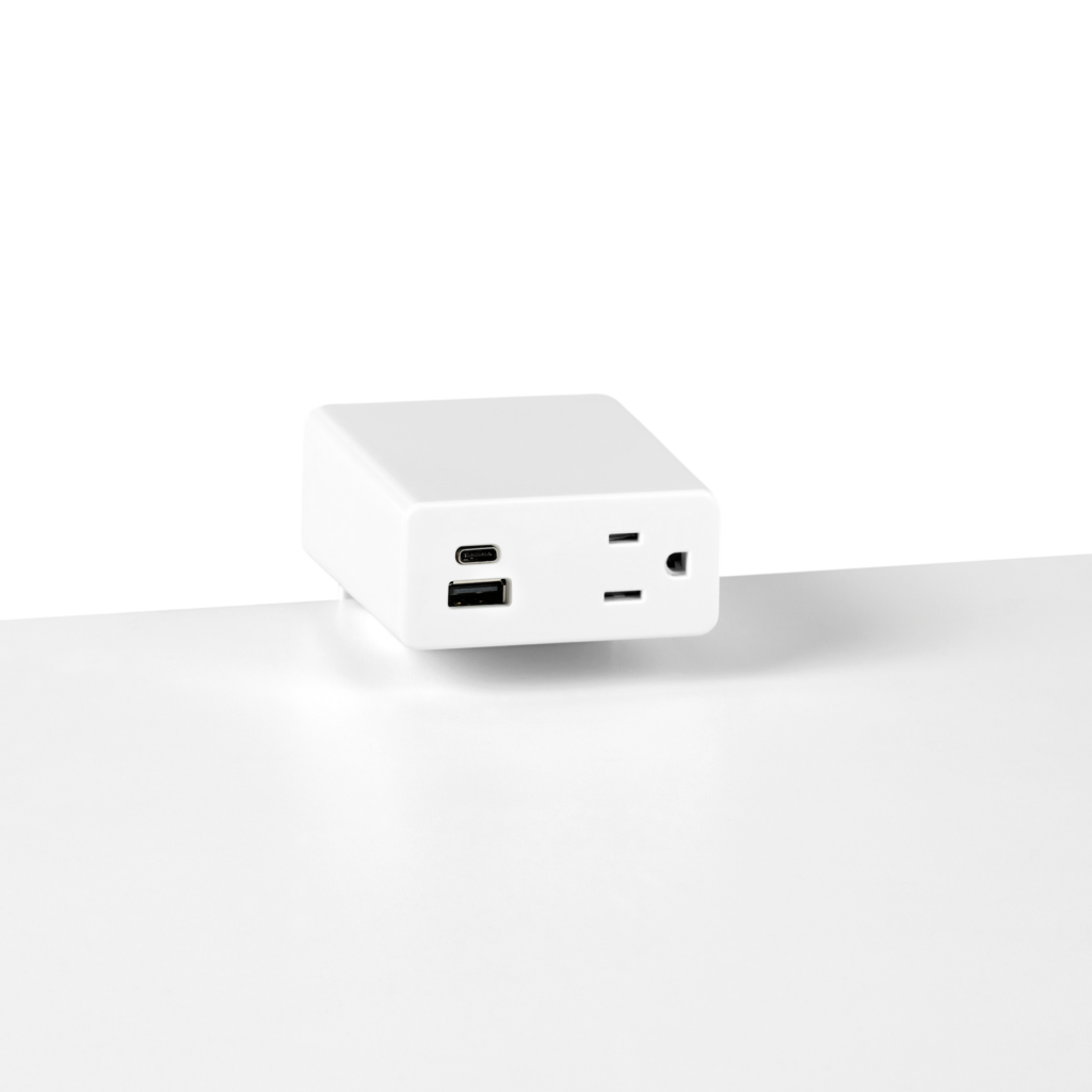 Close up image of a white surface mounted Logic Mini with two USB ports and one simplex receptacle.