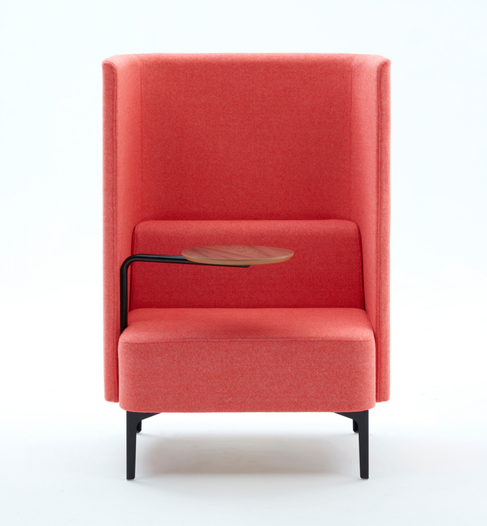 High back Pullman Chair upholstered in pink fabric, with black metal legs, and walnut veneer tablet arm on the right hand side.