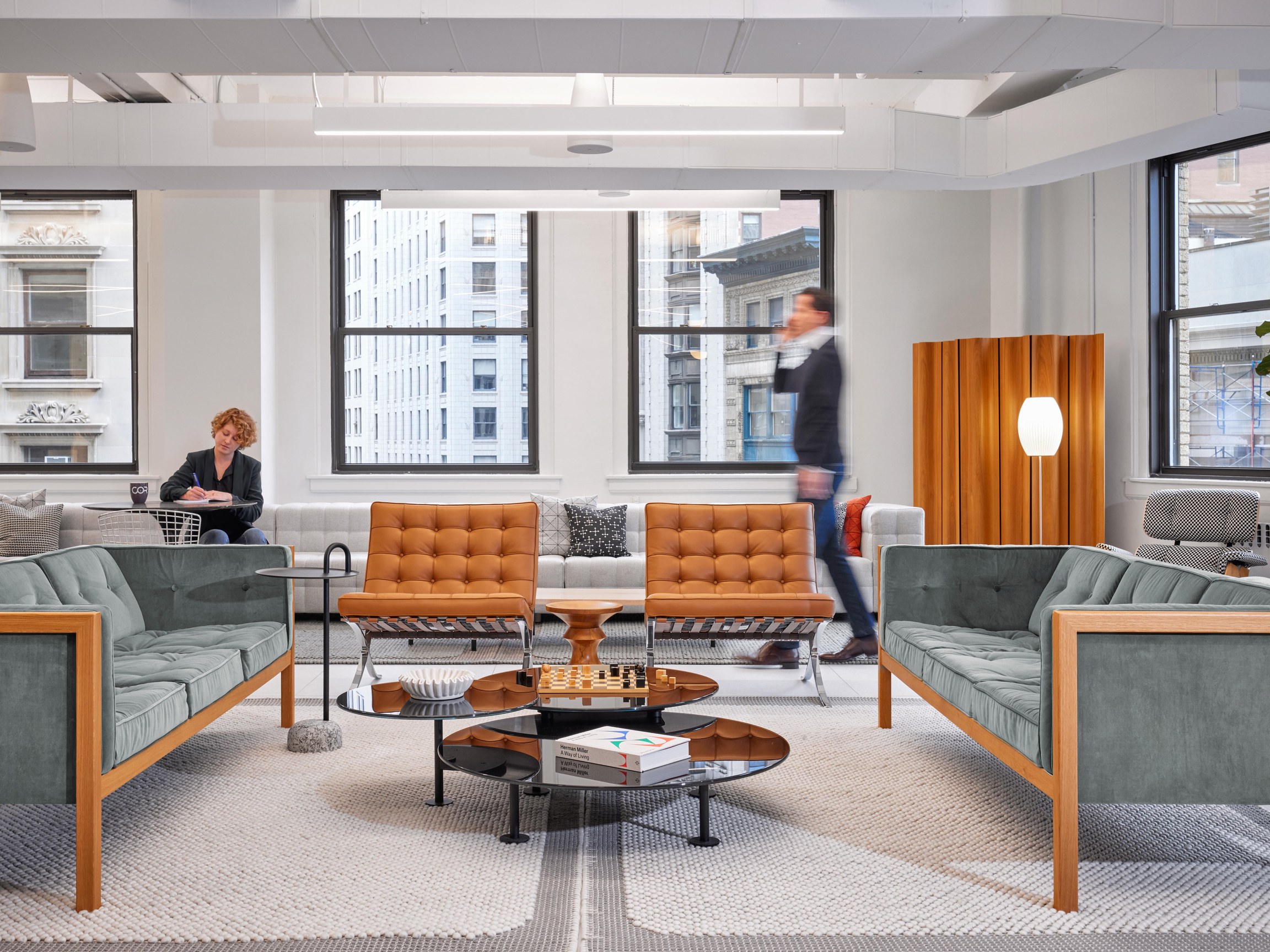 A COR lounge with Barcelona chairs, tufted sofas and a chess set on the coffee table