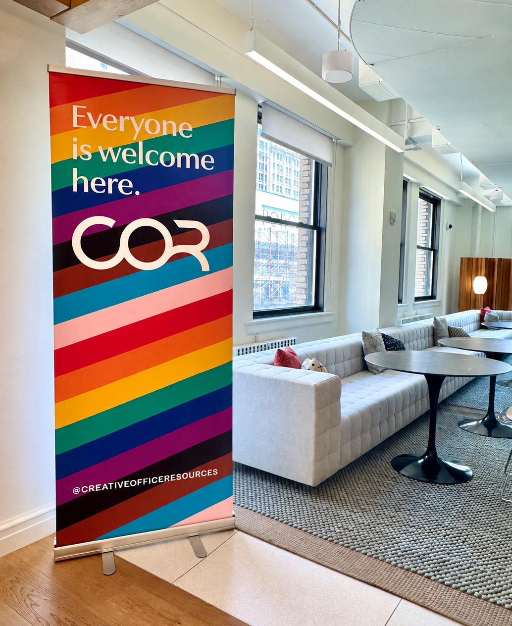 COR Everyone Is Welcome Here pride banner in a COR office